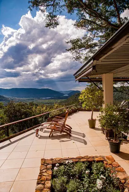 Amazing verandah deck with view and seating amongst tree canopies and treetops. House design by harare architect